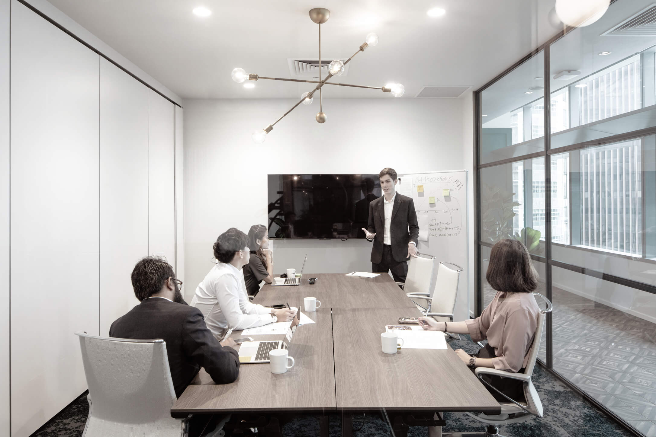 A group of professionals individuals holding a meeting discussion in one of One&Co's meeting room.