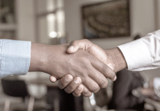 A pair of handshake symbolizing the conducting of international business through One&Co's community partner introduction service